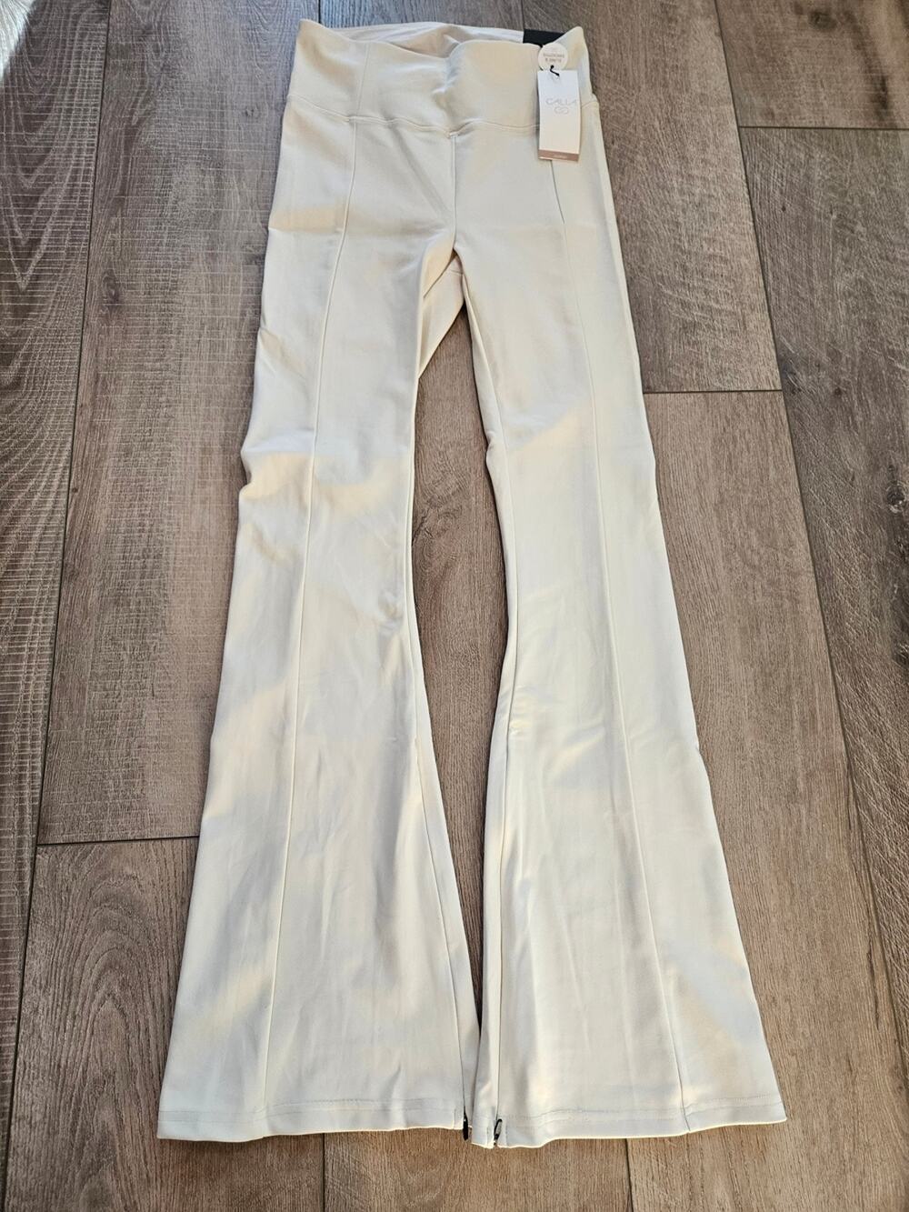 Calia High Rise Flare Leggings NWT Small Chantilly Cream Zip Hem